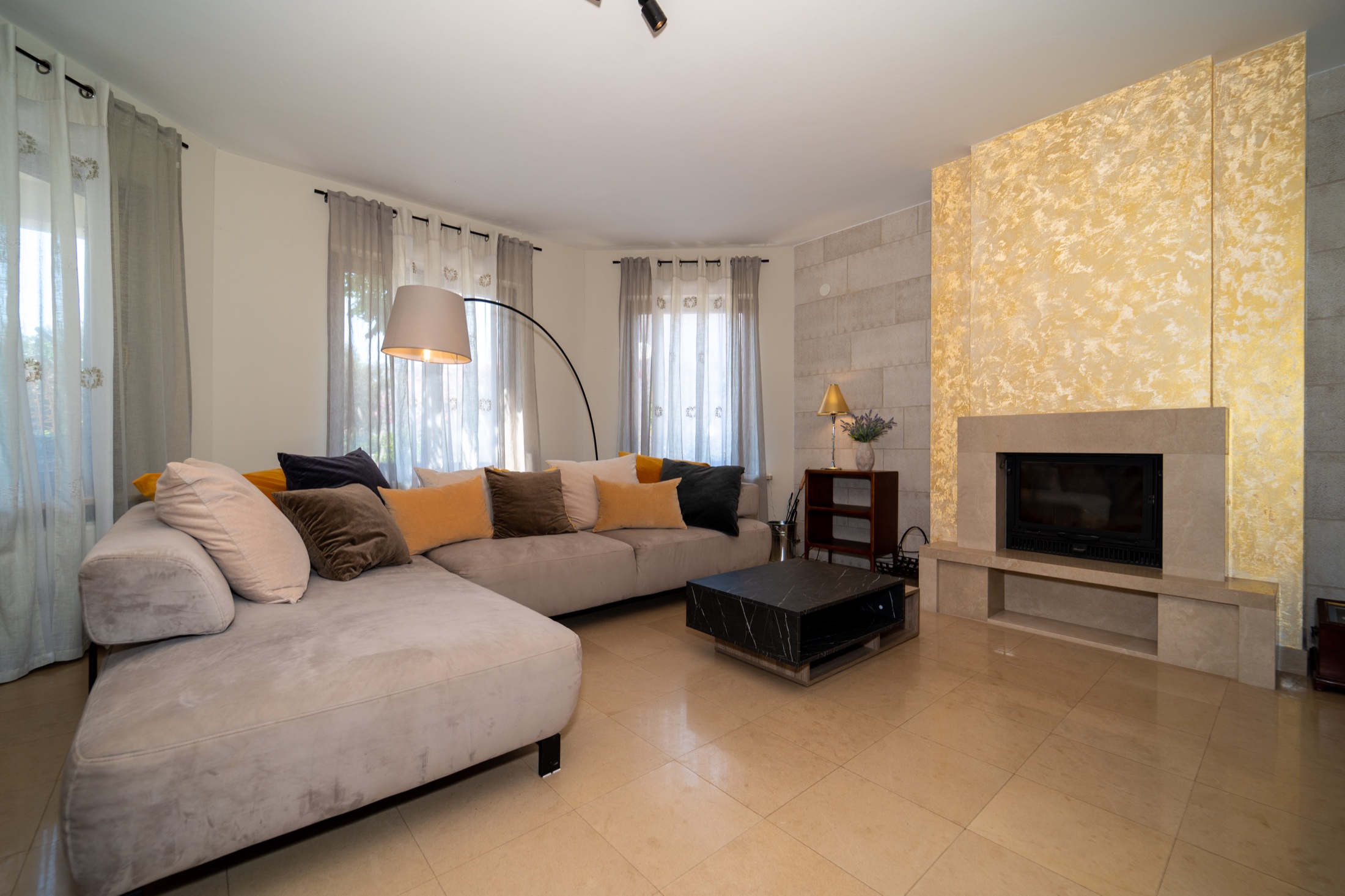 Villa Lostura’s warm living room beside the indoor fireplace